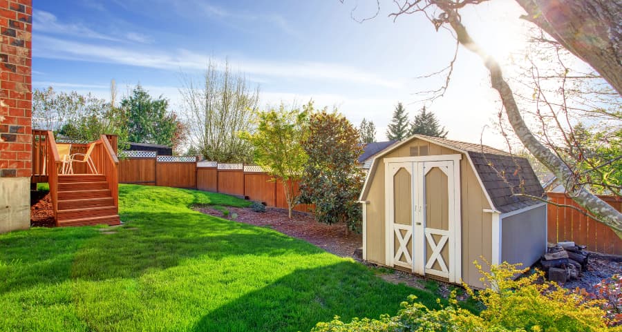 Fenced backyard with storage shed in Burlington